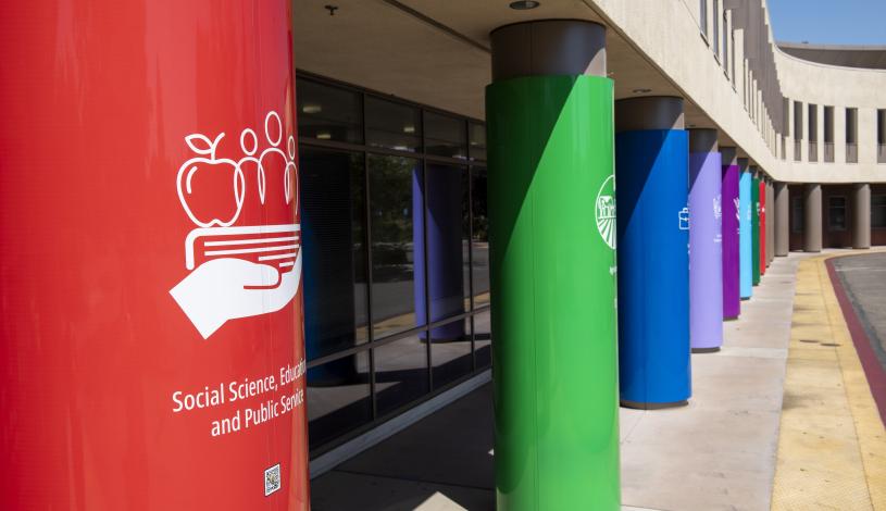 Close-up of TrAC colored pole wraps in front of DeRicco building