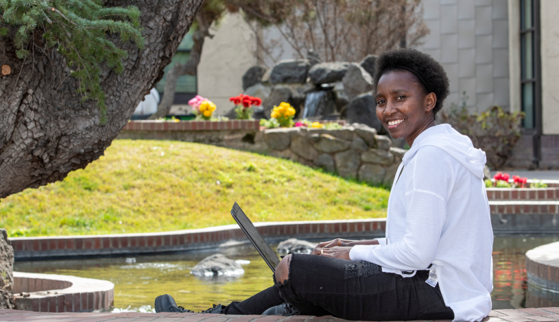 student smilling with laptop
