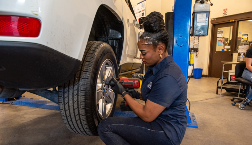 Student changing a tire