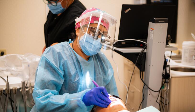 Dental student working on a patient