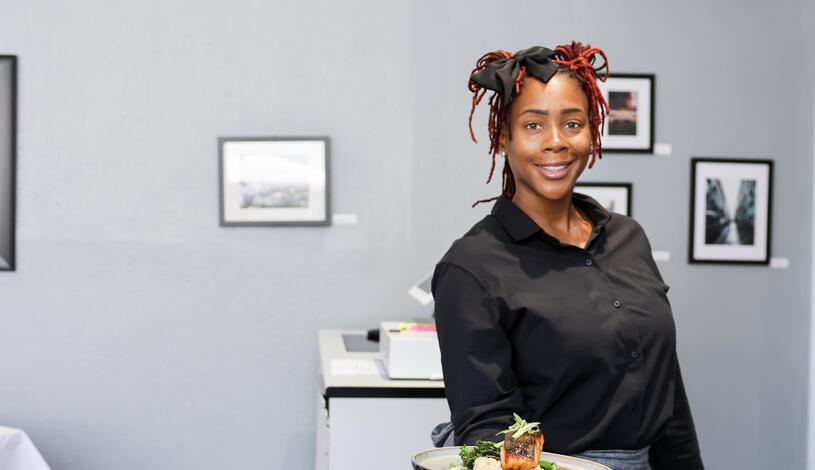 Student holding a plate of salmon
