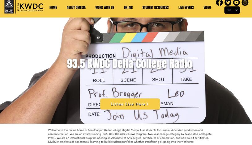 student holding a film slate labeled Digital Media to promote KWDC