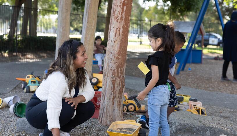 A child plays with a worker at the Child Development Center