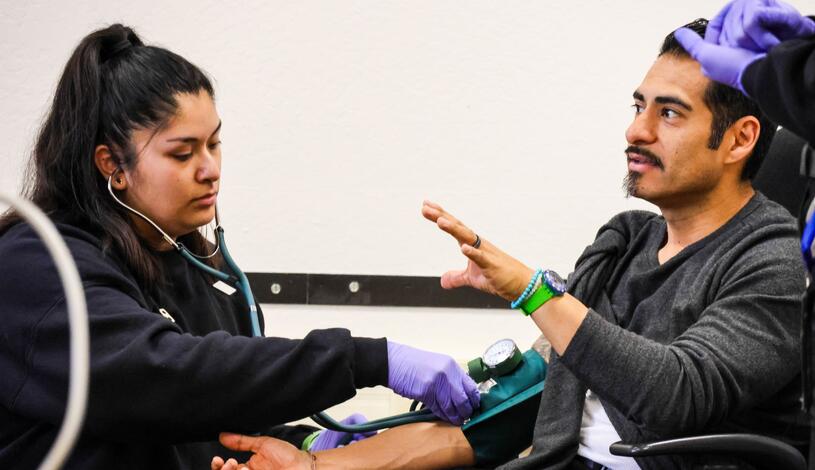 An instructor talks with EMT students