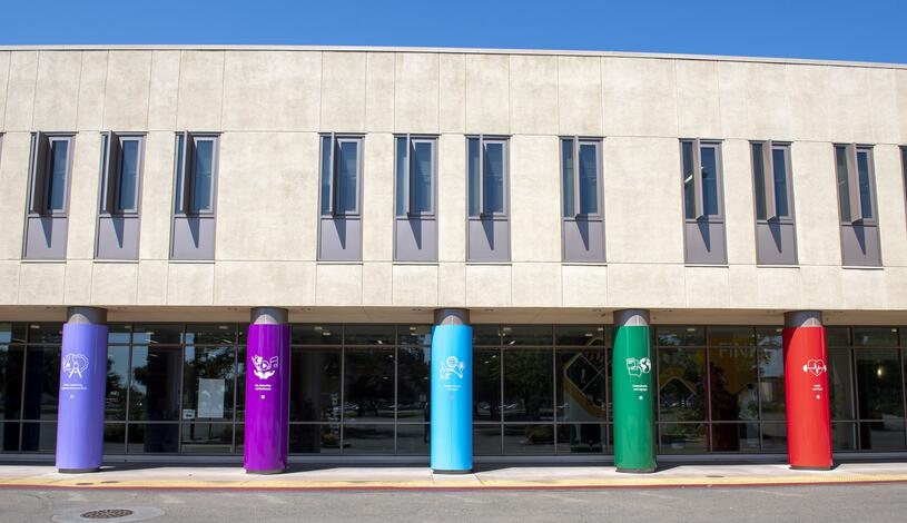 The front of the DeRicco Building with brightly colored TrAC pillars