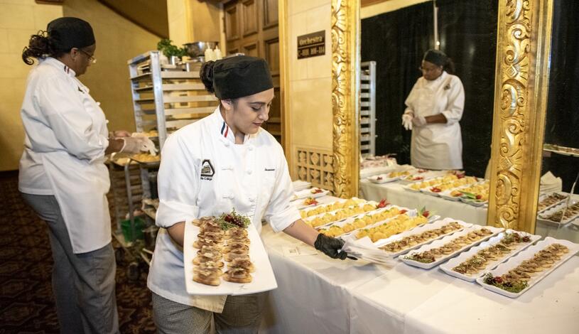 Students in theater setting up food