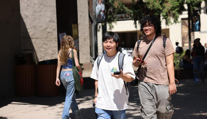 Two students walk through the Delta College quad