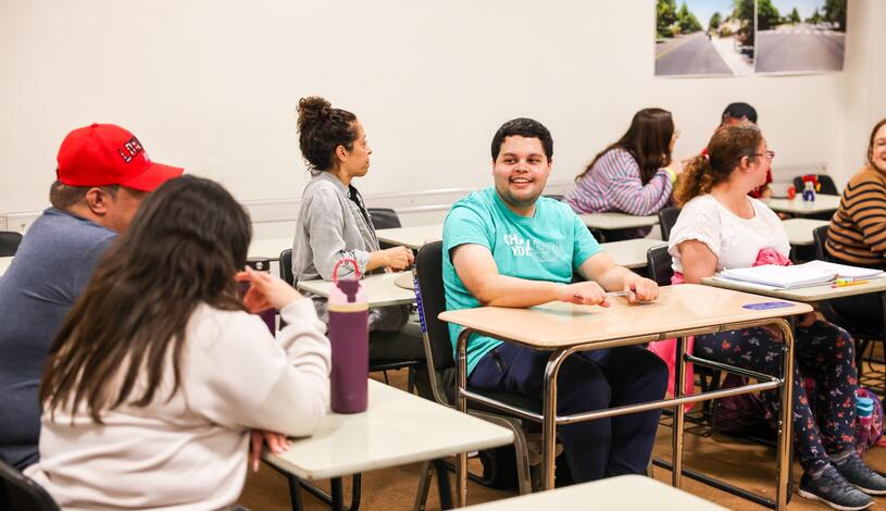 A DSPS student smiles during class