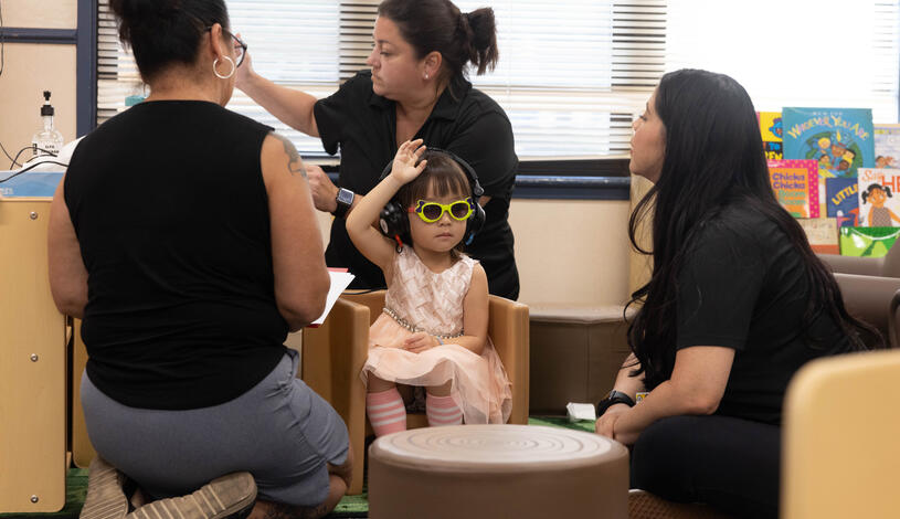 Speech Language Pathology Assistant students conduct a hearing check on a young girl
