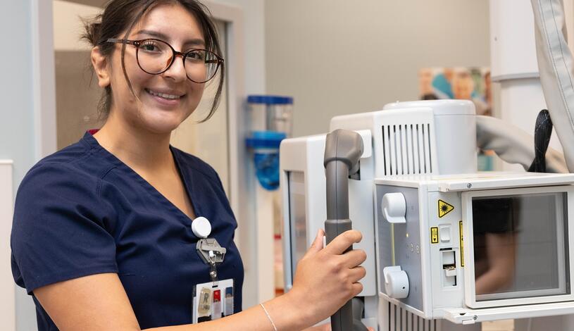 A radiologic technology student poses for a photo
