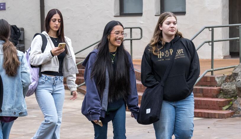 A student laughs as she walks through the Delta College Quad