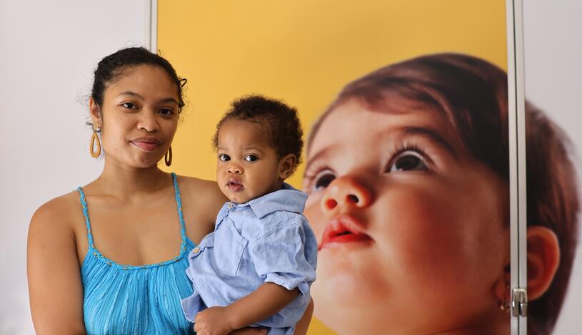A student and her child pose for a photo outside one of the new lactation pods.