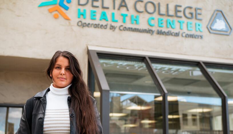 A student stands in front of the Delta College Health Center