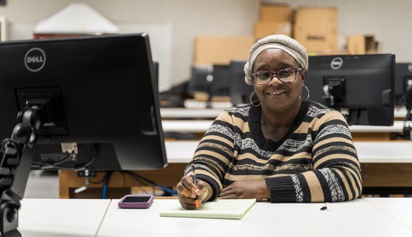 A business student smiles while in class