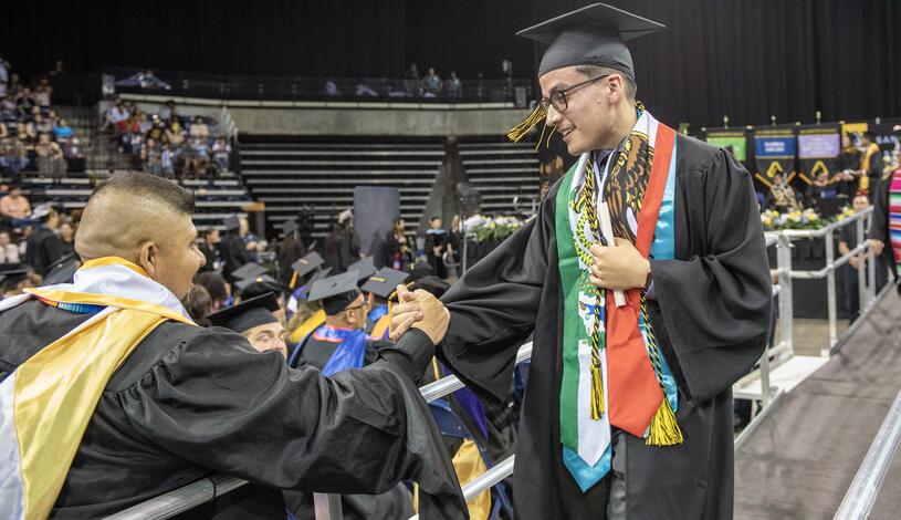 Photo of a student leaving the stage after Commencement