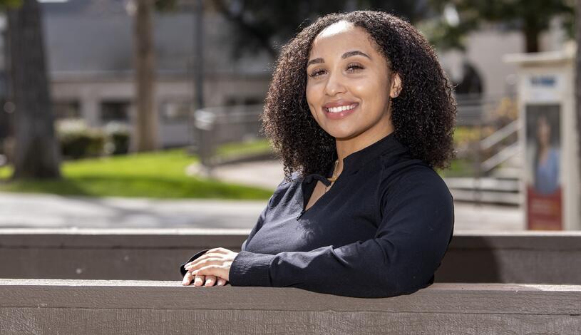 Photo of a Delta College student posing on the bridge near the Quad