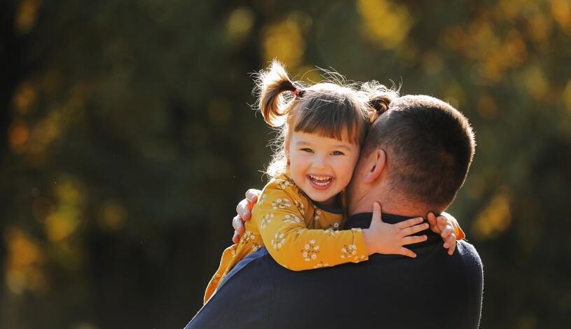 Photo of a foster parent hugging his child