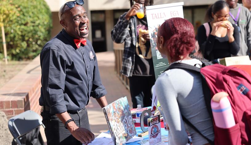 Photo of a representative from a Historically Black College/University visiting with Delta students
