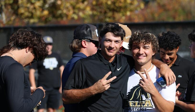 Photo of two baseball players smiling at the grand reopening of the Chase Chevrolet Athletic Complex