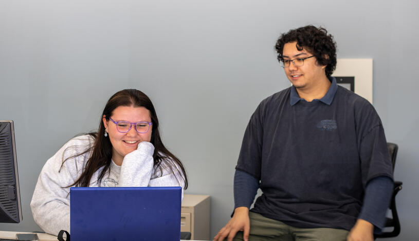 Student and employer working together on a laptop