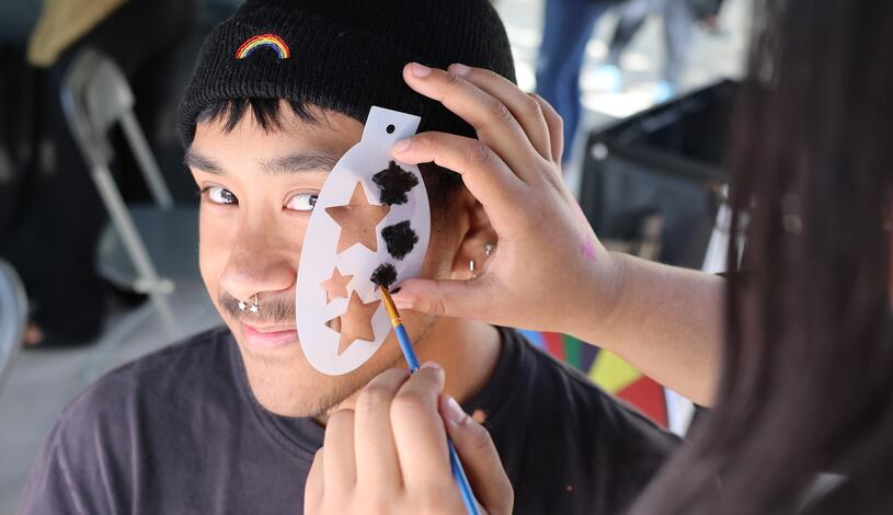 Photo of a student having his face painted