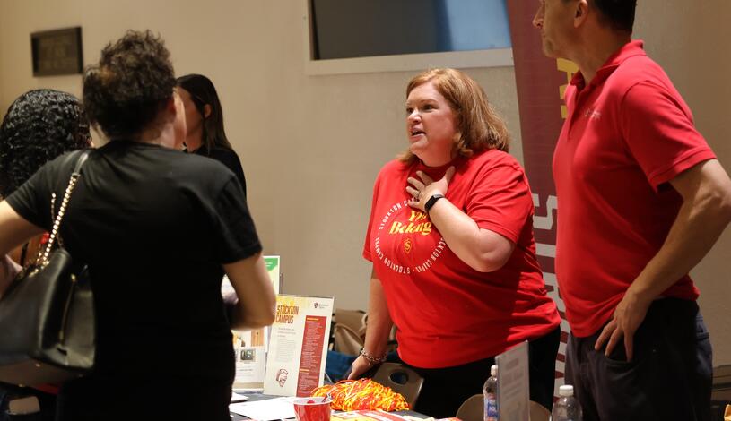 Photo of representatives from Stanislaus State visiting with Delta students