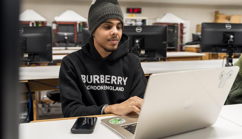 Photo of a Business Information Management student in class