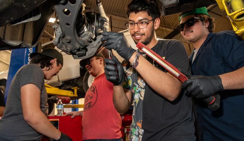 Photo of an automotive student working on a car