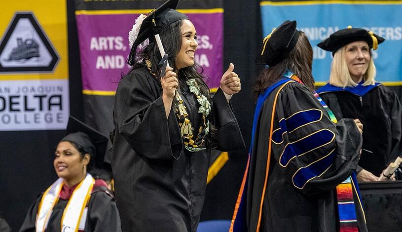 Photo of a student crossing the stage at Commencement.