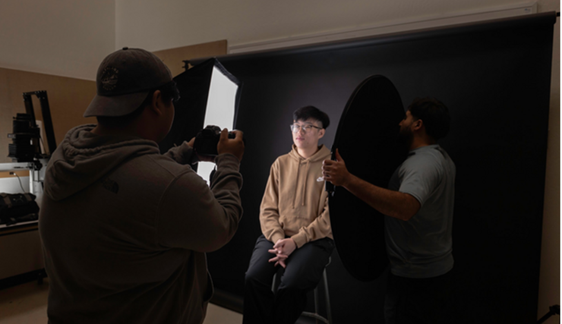 Photo of photography students using equipment in the lab