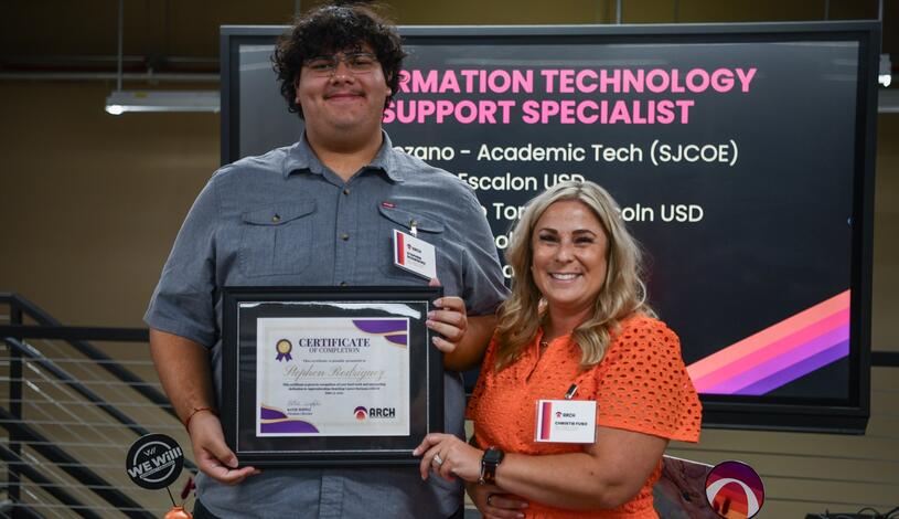 A student celebrates completion of the IT support specialist apprenticeship program
