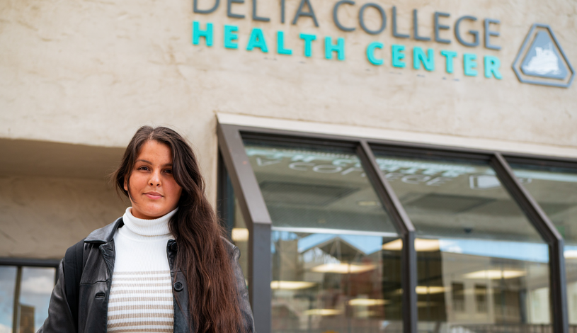 Student in front of Health Center