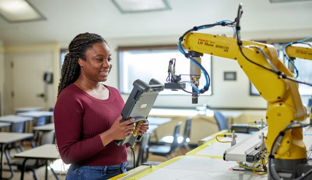 girl testing a robot arm