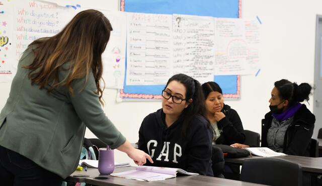 An ESL instructor works with a student