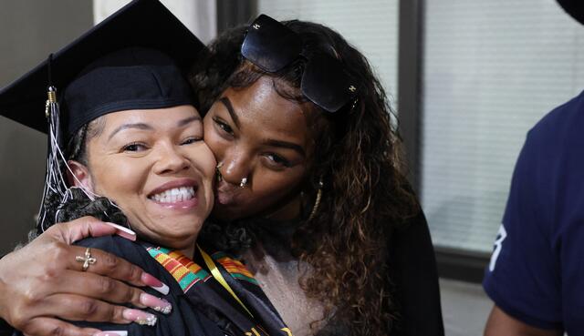 A student is congratulated after finishing her Delta education