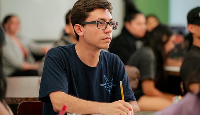 A student focuses on the instructor during a lesson on nutrition