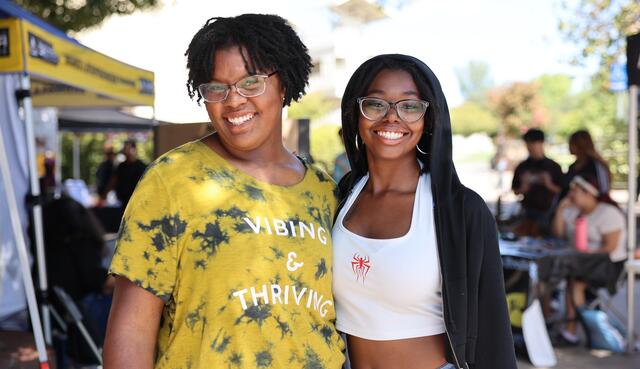 Two students pose for a photo in the Delta College quad