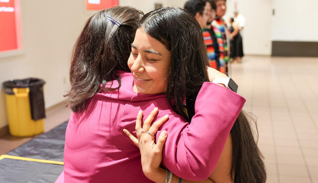 Photo of a Puente graduate getting a hug