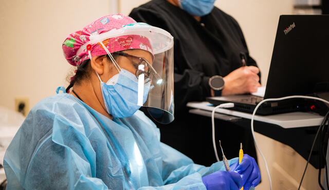 Photo of a dentist providing care at the Delta College Health Center