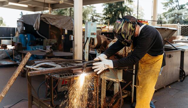 Photo of a welder with sparks flying