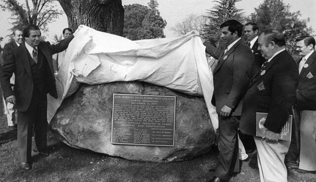 Black and white photo of a group of men unveiling of Dedication Rock in 1977