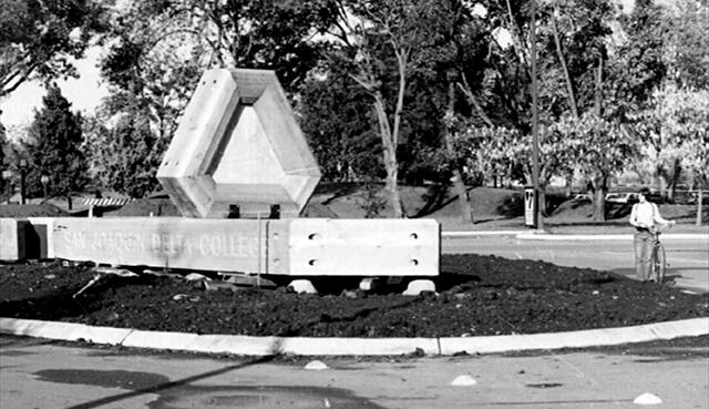 Black and white photo of the Delta College logo sign on campus in 1974