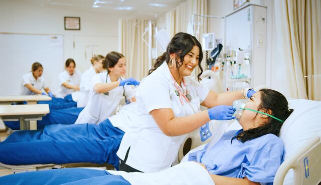 Photo of nursing students practicing in the lab