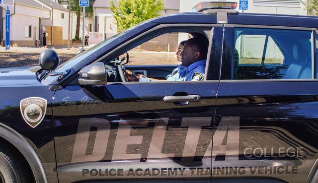 Photo of police cadets in a Delta College police vehicle