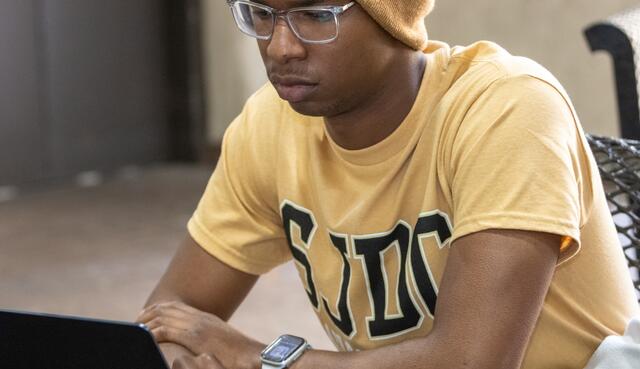 A student uses his laptop between classes