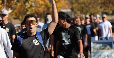 A Delta College athlete puts his arm in the air in celebration of Delta's new fields