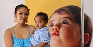 A student and her child pose for a photo outside one of the new lactation pods.