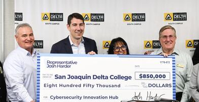 Photo of Congressman Josh Harder presenting a check to Delta College