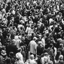 People stand in crowded street