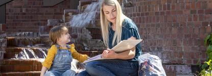 Photo of a student parent and her daughter studying at Budd